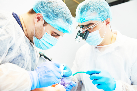 two male dentists replacing a patient's missing teeth
